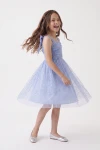 Abito Rina azzurro fiordaliso – gonna svasata in tulle con paillettes e pois durante una giravolta