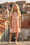 Abito Sia rosa per bambina – figura intera frontale sullo sfondo del centro storico